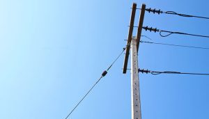 Utility guy wire stabilizing overhead power lines