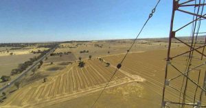 Utility guy wire stabilizing overhead power lines
